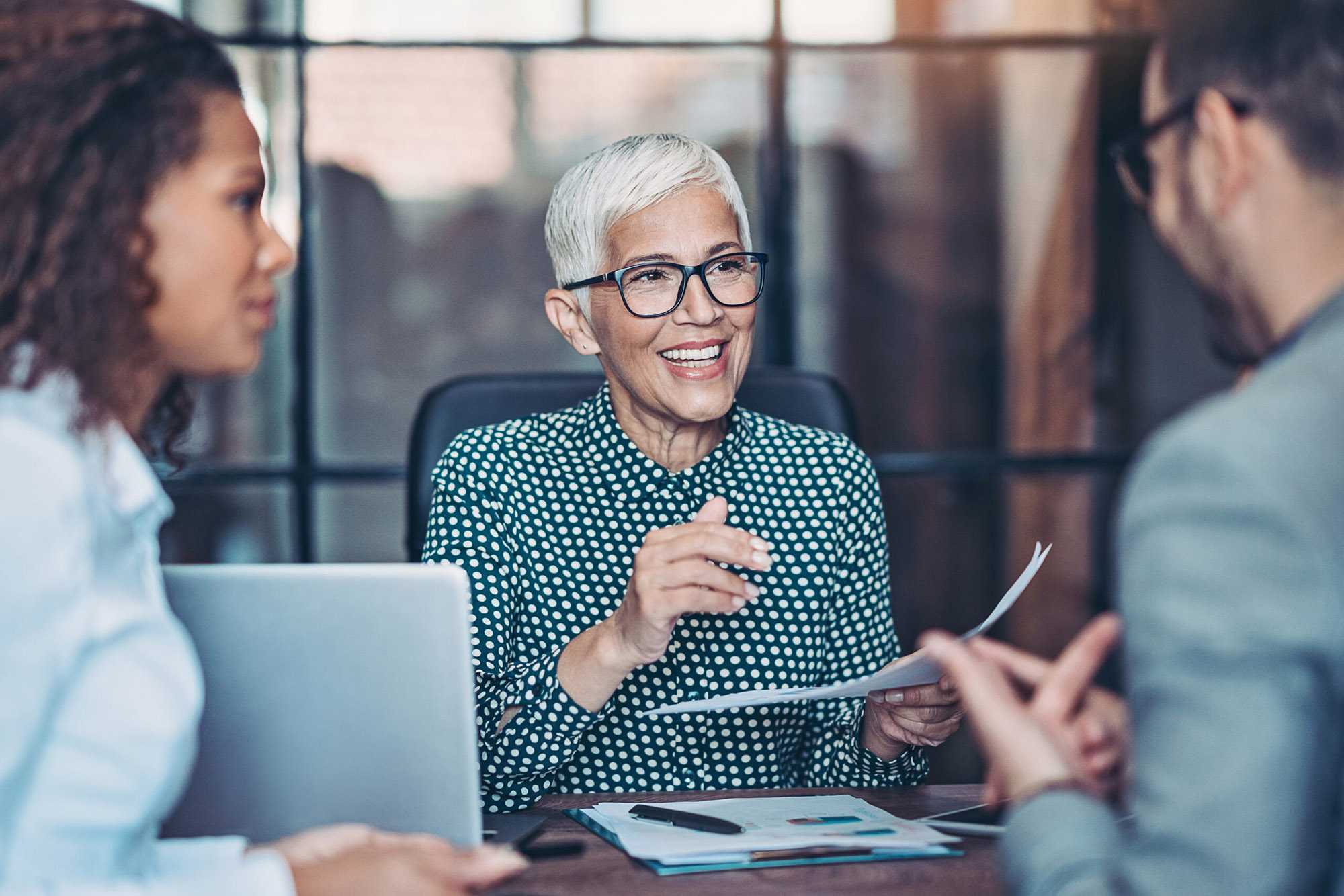 Senior businesswoman talking to her team